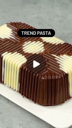 a chocolate cake with white and brown icing on it's side that says trend pasta