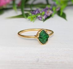 Uniquely handcrafted with a natural raw green Garnet, this raw gemstone ring is a true testament to the beauty of natural, unpolished crystals. The rich, lush forest green of the Garnet is captivating and alluring, while the raw, uncut edges give it an earthy, organic feel. The perfect gift for that very special person in your life, whether as a promise ring or simply as an everyday accessory, this lovely ring represents a commitment to love and a dedication to ethical, sustainable craftsmanship Green Stone Ring Engagement, Green Crystal Ring, Raw Stone Engagement Rings, Ring With Gemstone, Rough Gemstone Jewelry, Rough Gemstone Ring, Garnet Engagement Ring, Lush Forest, Raw Gemstone Ring