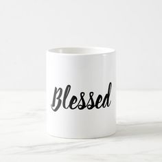 a white coffee mug with the word blessed printed on it