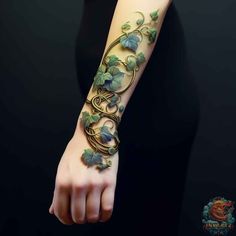 a woman's arm with vines and leaves on it, in the shape of a vine