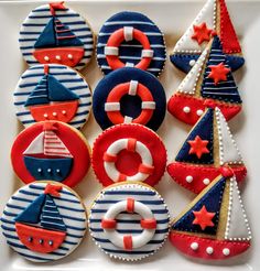 decorated cookies in the shape of boats, ships and life preservers on a plate