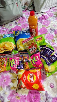 various snacks are laid out on a bed