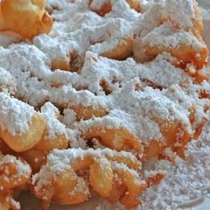 a homemade funnel cake with powdered sugar on top and the words homemade funnel cakes above it