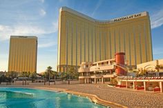 a large hotel with a pool in front of it