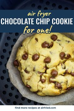 a chocolate chip cookie in a pan with the words air fryer chocolate chip cookies for one