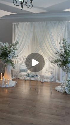 a room filled with white flowers and candles