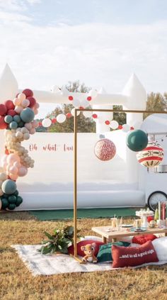 an outdoor party with balloons and decorations