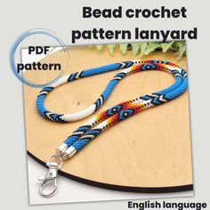 a blue and white braided lanyard on a wooden table with the words bead crochet pattern