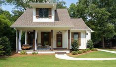 a small white house with brown shutters