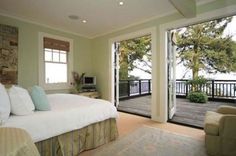 a large bed sitting inside of a bedroom on top of a hard wood floor