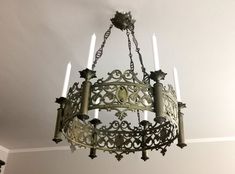 a chandelier hanging from the ceiling in a room with white walls and flooring