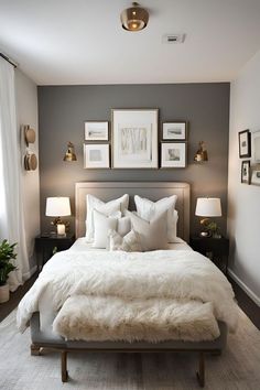 a white bed sitting in a bedroom next to two lamps and pictures on the wall