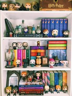 a book shelf filled with lots of books and figurines on top of it