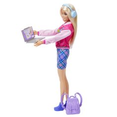 a barbie doll with headphones on holding a laptop in one hand and a purse in the other