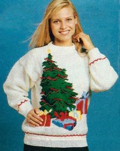 a woman wearing a christmas sweater with a tree on it