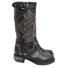 Introducing the Baldan Black Leather Studded Moto Boots, a bold and edgy statement piece that's perfect for those who crave the motorcycle-inspired vibe with a touch of rebellious elegance. These classic black leather boots exude the iconic Moto style with a twist of high-fashion flair. They are designed to capture the essence of motorcycle culture while adding a touch of glamour to your ensemble. The defining feature of these boots is the plethora of intricately arranged studs that adorn them. Every stud is meticulously placed, creating a dynamic visual impact that sets these boots apart. The studs add an edgy and rebellious element to your look, making them ideal for those who want to make a statement. At the top of these boots, you'll find a distinctive buckle detail that not only adds Gucci Leather Jacket, Nordstrom Boots, Hog Heaven, Miu Miu Dress, Biker Look, Boots Tall, Awesome Shoes, Makeup Sale, Boots Style