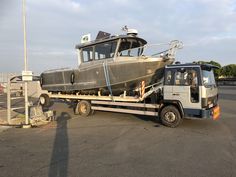 a truck towing a boat on the back of it