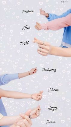 four hands reaching out to each other with hearts on the wall behind them and words written in different languages