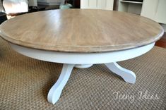 a white table with a wooden top on a rug