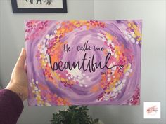 a person holding up a painting with the words he could have beautiful on it