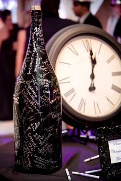 a bottle with writing on it next to a clock