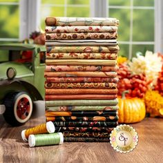 a stack of fabric sitting on top of a wooden table next to a green truck