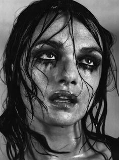 a black and white photo of a woman with wet hair