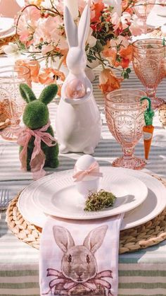 a table set for easter with bunny napkins