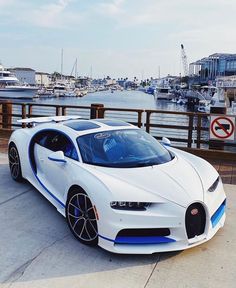 a white bugatti parked on top of a pier