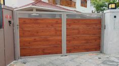 a wooden gate in front of a house