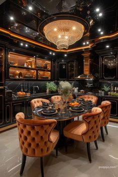 a dining room table with orange chairs and black counter tops in front of an oven