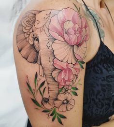 an elephant with flowers on it's shoulder is shown in this tattoo art photo