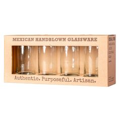 the mexican hand blown glassware set includes four glasses and one is in a cardboard box