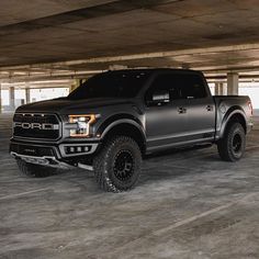 a black truck parked in a parking garage