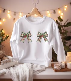 This Christmas bows sweatshirt for women exudes festive vibes, perfect for the holiday season. Made with a cozy blend of 50% cotton and 50% polyester, it offers a classic fit with a crew neckline for comfort and style. Ideal for women looking to stay warm and stylish during the holidays. Please note that these sweaters are unisex sizing. Please refer to the sizing chart to find your perfect fit. For the ladies, please order your normal size for a regular fit, or size down for a more fitted look. Bow Women, Winter Sweater, Christmas Bows, Look Plus, Winter Sweaters, Holiday Festival, Sizing Chart, Festival Season, Stay Warm