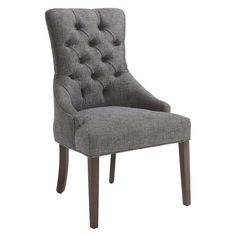 an upholstered chair with buttons on the back and legs, in grey fabric