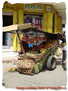 there is a fruit stand on the side of the road