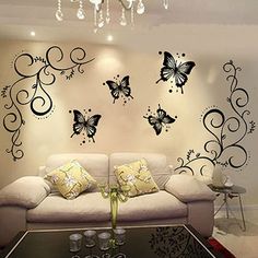 the living room is decorated with black and white butterflies on the wall, along with a chandelier