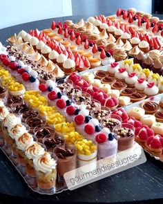 a table topped with lots of different types of desserts