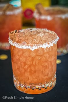 two cocktails sitting on top of a table next to each other