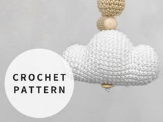 a crochet cloud hanging from a hook with the words crochet pattern below it