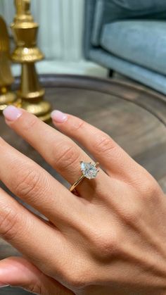 a woman's hand with a diamond ring on it