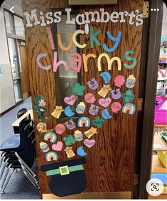 a classroom door decorated with magnets and paper hearts that say, miss lombrert's lucky charms