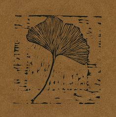 a drawing of a large leaf on top of a brown piece of paper with black ink