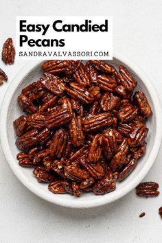 a white bowl filled with pecans on top of a table