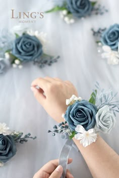 the brides bouquet is being tied to her wrist with a satin ribbon and flowers