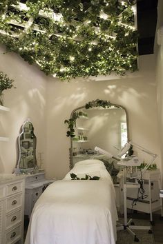 a room with a bed, mirror and plants on the ceiling