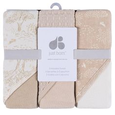 the just born baby blanket set has four different colors and patterns, including beiges, white