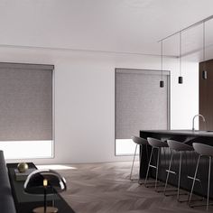 a living room filled with furniture next to a kitchen counter covered in black and white blinds