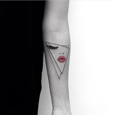 a woman's arm with an origami tattoo on the left inner forearm